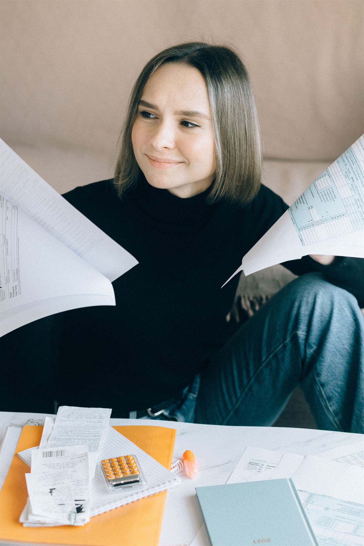 A person reviewing tax paperwork before meeting an accountant